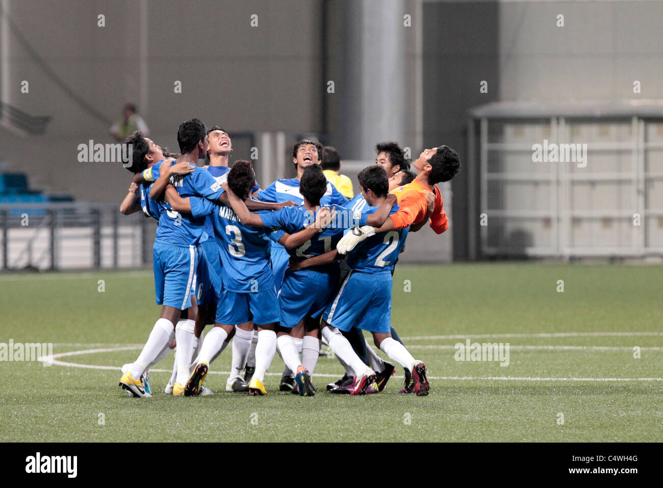 Singapore U15 players in a team huddle before their semi-final match of the 23rd Canon Lion City Cup. Stock Photo
