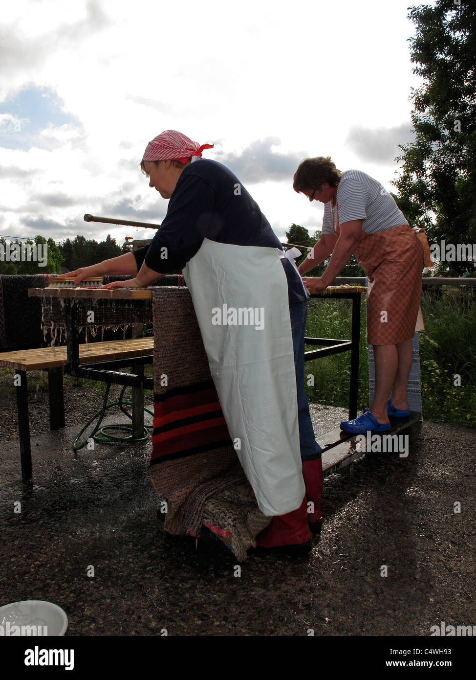 Scandinavia Finnish housewife cleaning carpet in open air facility Stock Photo Alamy