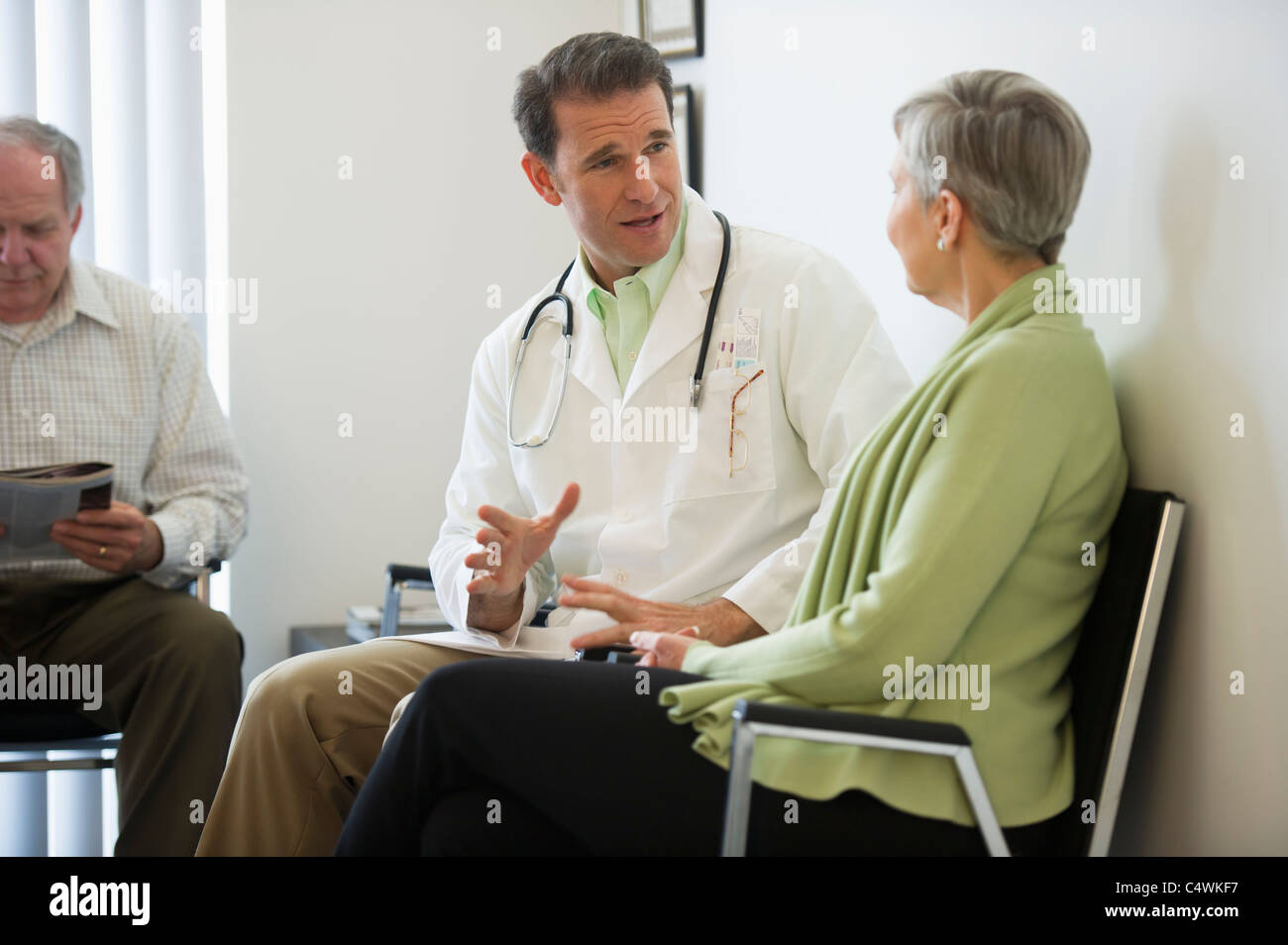 USA, New Jersey, Jersey City, Senior couple talking to doctor Stock Photo