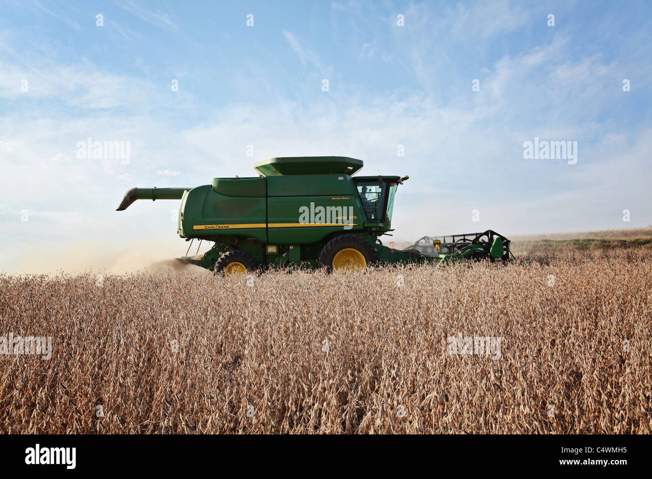 John Deere combine harvesting soybeans in a field in Iowa Stock Photo