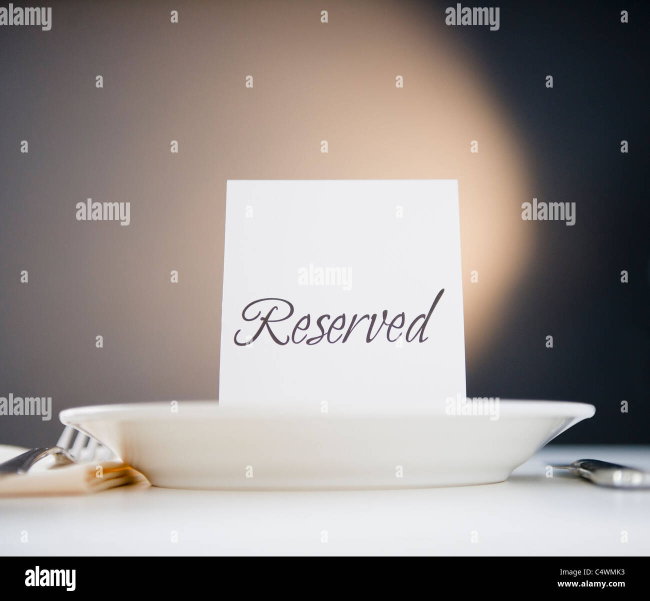 Reserved sign on place setting, studio shot Stock Photo