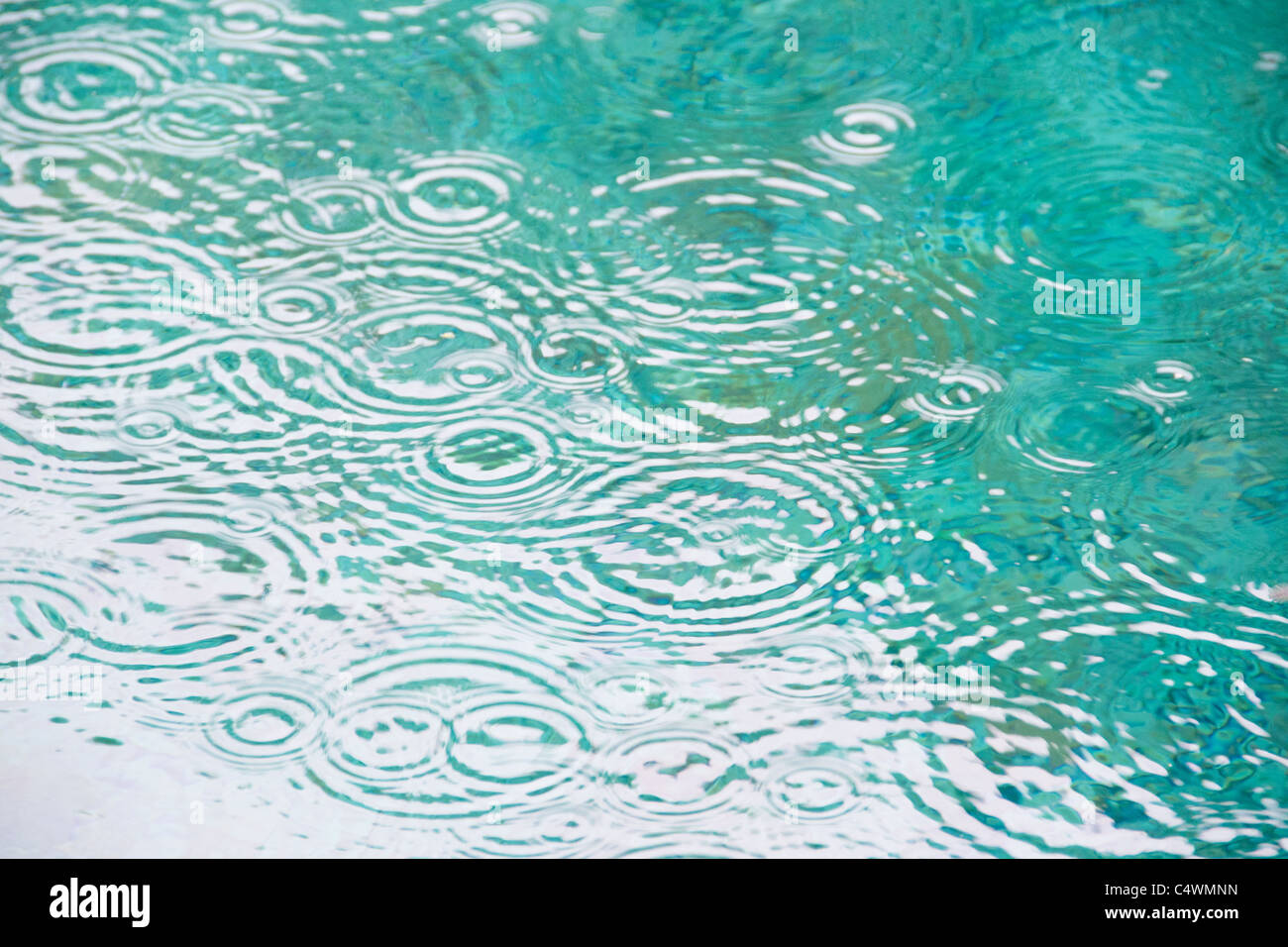 Brazil, Bahia, Trancoso, Raindrops on falling on pond surface Stock Photo