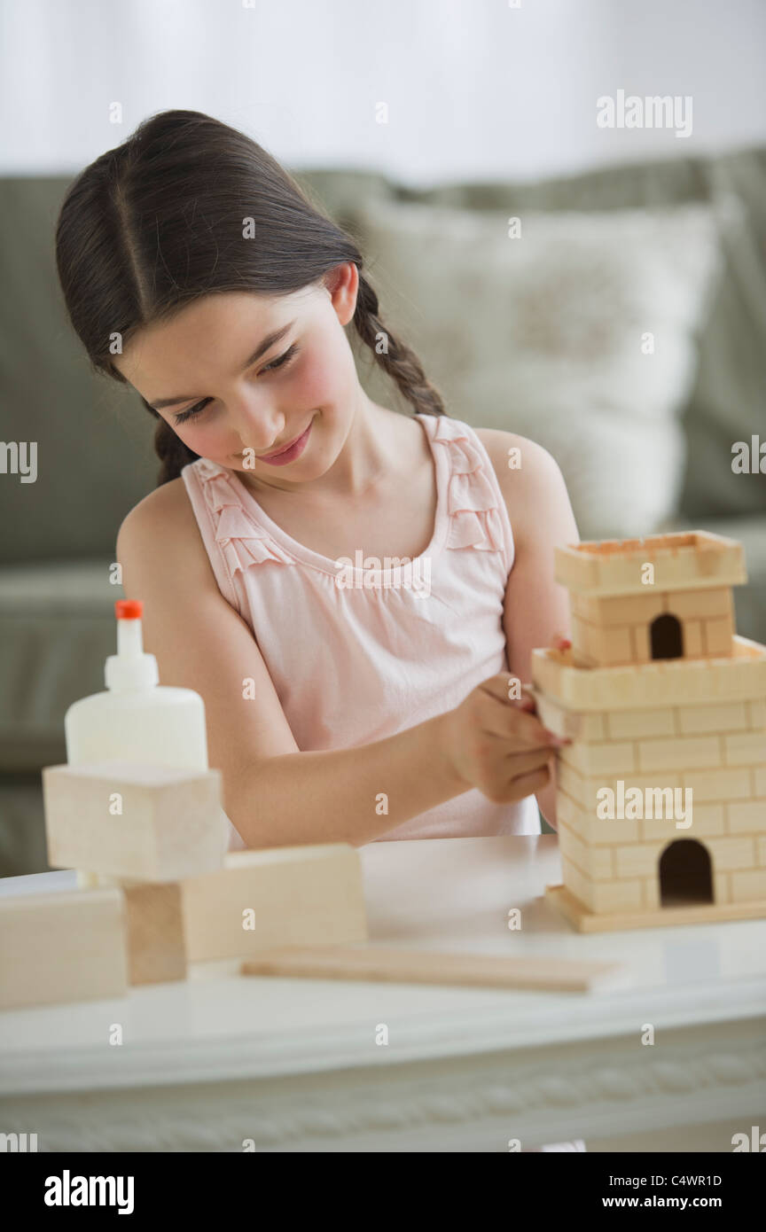 USA,New Jersey,Jersey City,girl (8-9) building toy castle Stock Photo