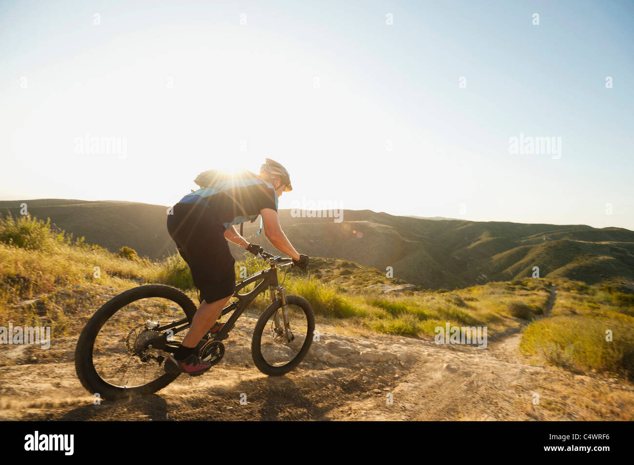 USA,California,Laguna Beach,Mountain biker riding downhill Stock Photo
