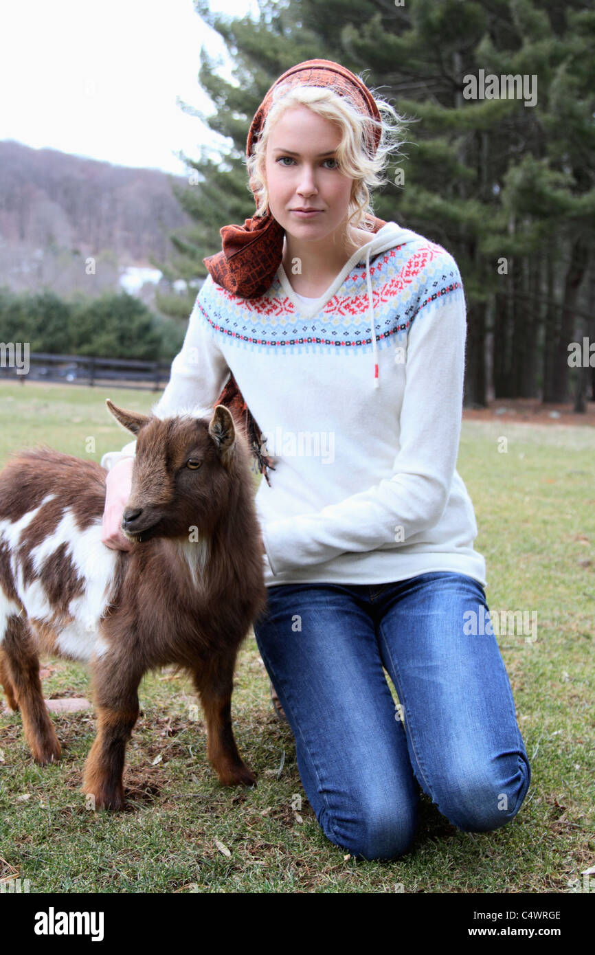 USA,New Jersey,Califon,Young woman at farm with young goat Stock Photo