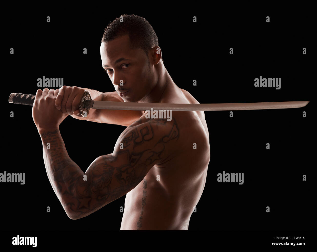 Studio shot of martial arts practitioner with Katana sword Stock Photo