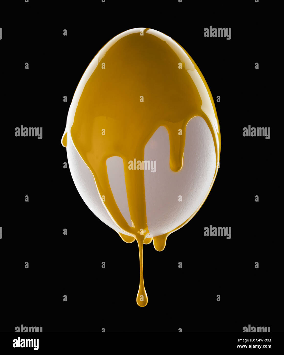 Studio shot of egg covered with yellow paint Stock Photo