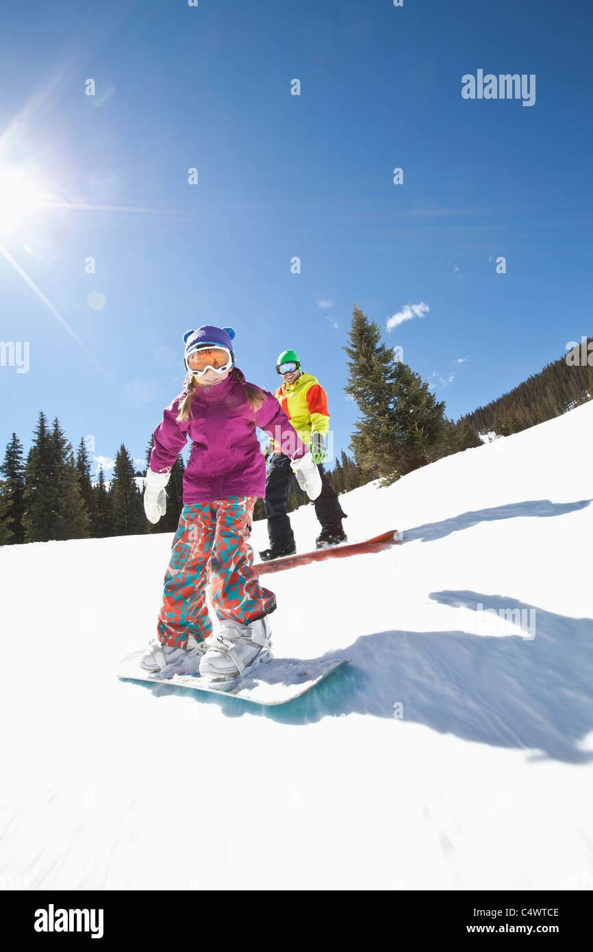 USA,Colorado,Telluride,Father and daughter (10-11) snowboarding Stock Photo