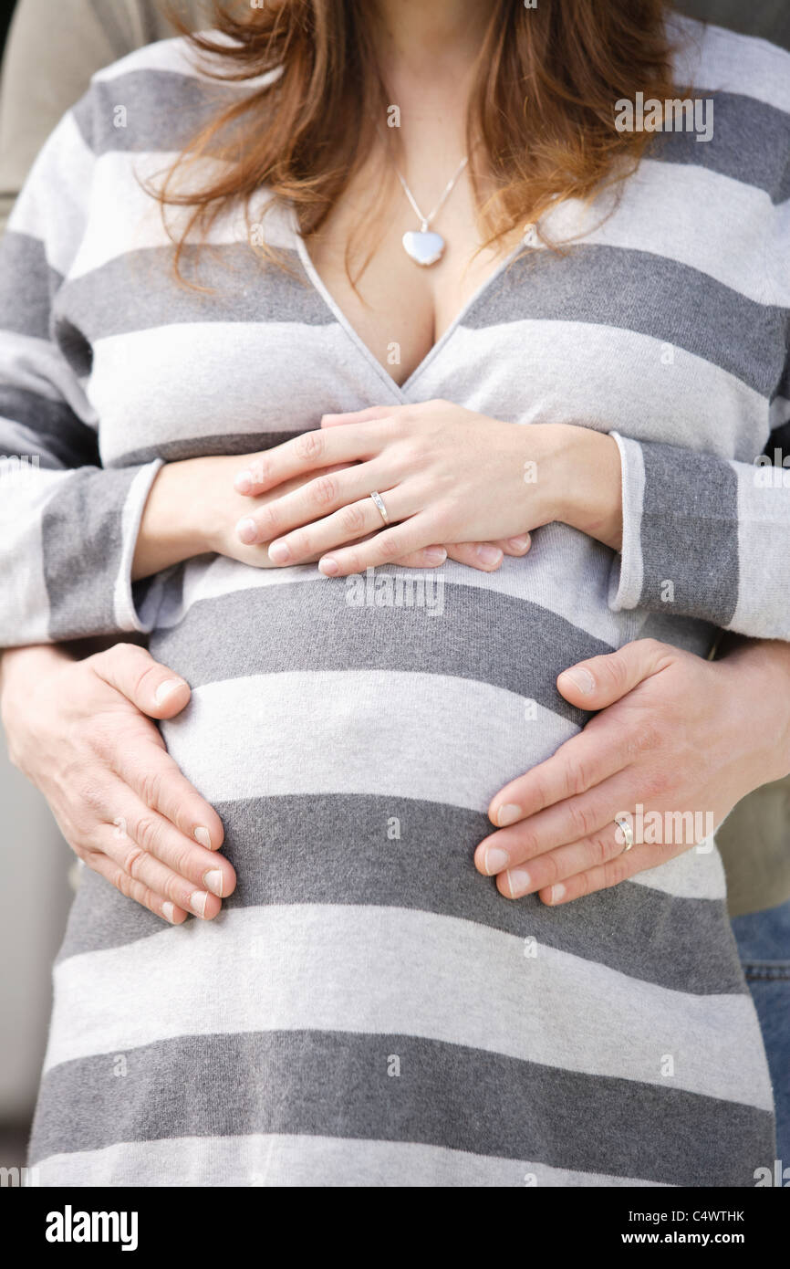 USA,California,Los Angeles,man's hands on pregnant woman's belly Stock Photo