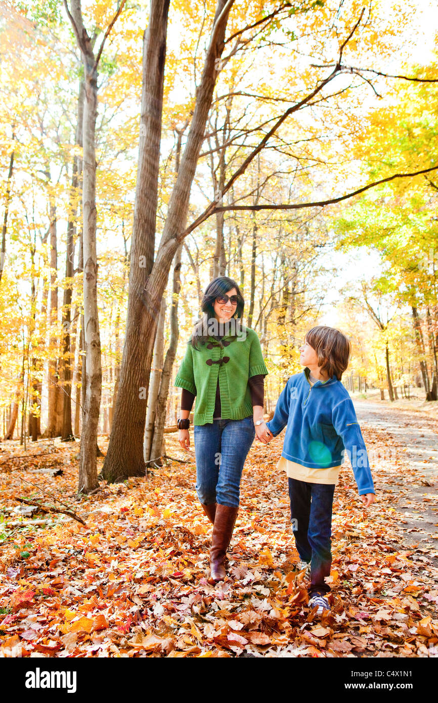 Mother walking with son in forest Stock Photo