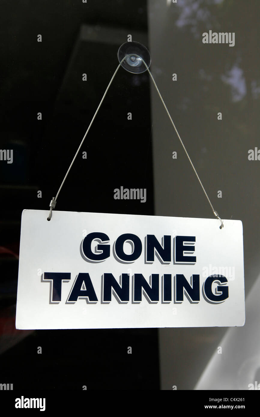 A shop sign says "Gone Tanning" in Lisbon, Portugal. Stock Photo
