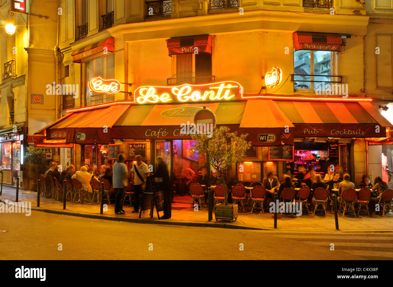 People sitting outside a restaurant in St Germain area of Paris at night Stock Photo