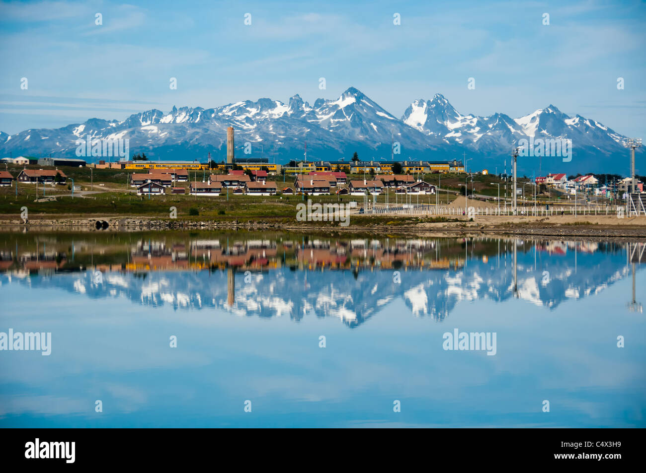 Snowy mountains reflect in the ocean at Ushuaia, Tierra del Fuego, Argentina. Stock Photo
