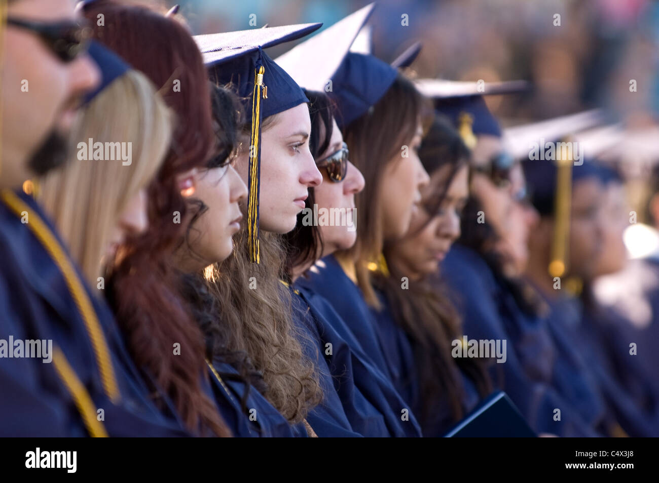 At the Fullerton graduation ceremony a row of graduating seniors wait. Stock Photo