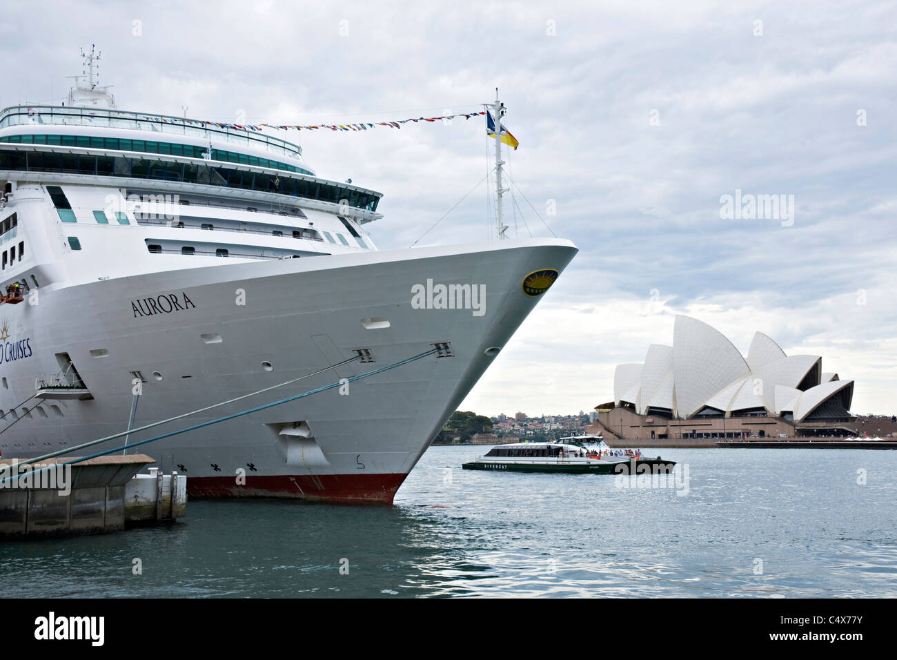 The Bow Of The P O Cruise Ship Aurora Berthed At The Overseas Passenger Terminal Overshadows The Sydney Opera House Australia Stock Photo Alamy