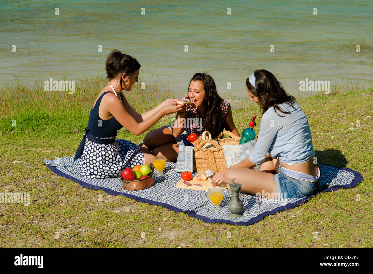 Girls enjoying a classic picnic in a scenic setting Stock Photo Alamy