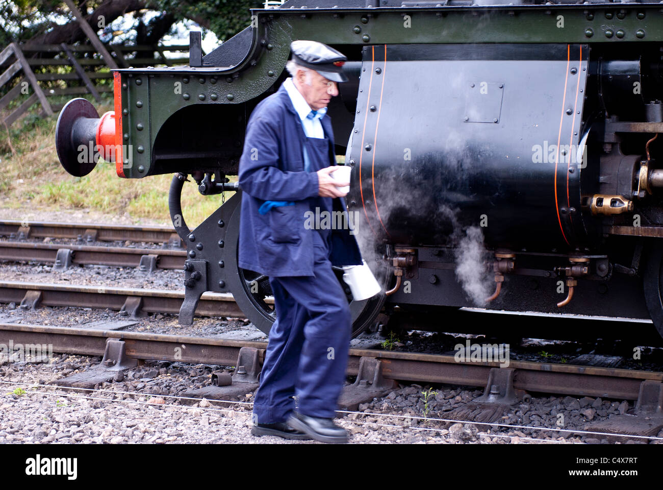 Steam train driver by steam engine. Toddington, Gloucestershire