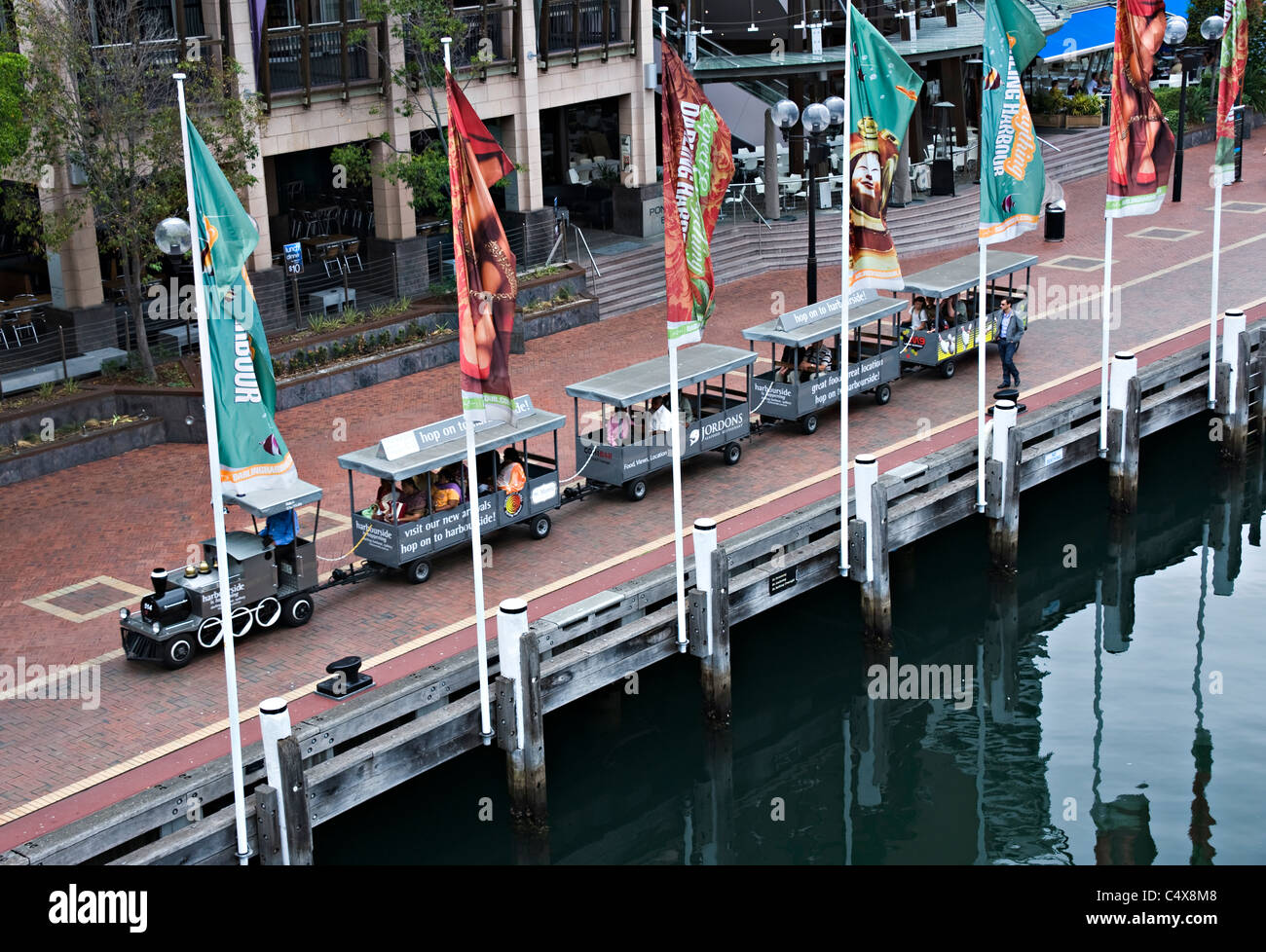 The Charming Cockle Bay Wharf with Shops and Tourist Train at Darling Harbour Sydney New South Wales NSW Australia Stock Photo
