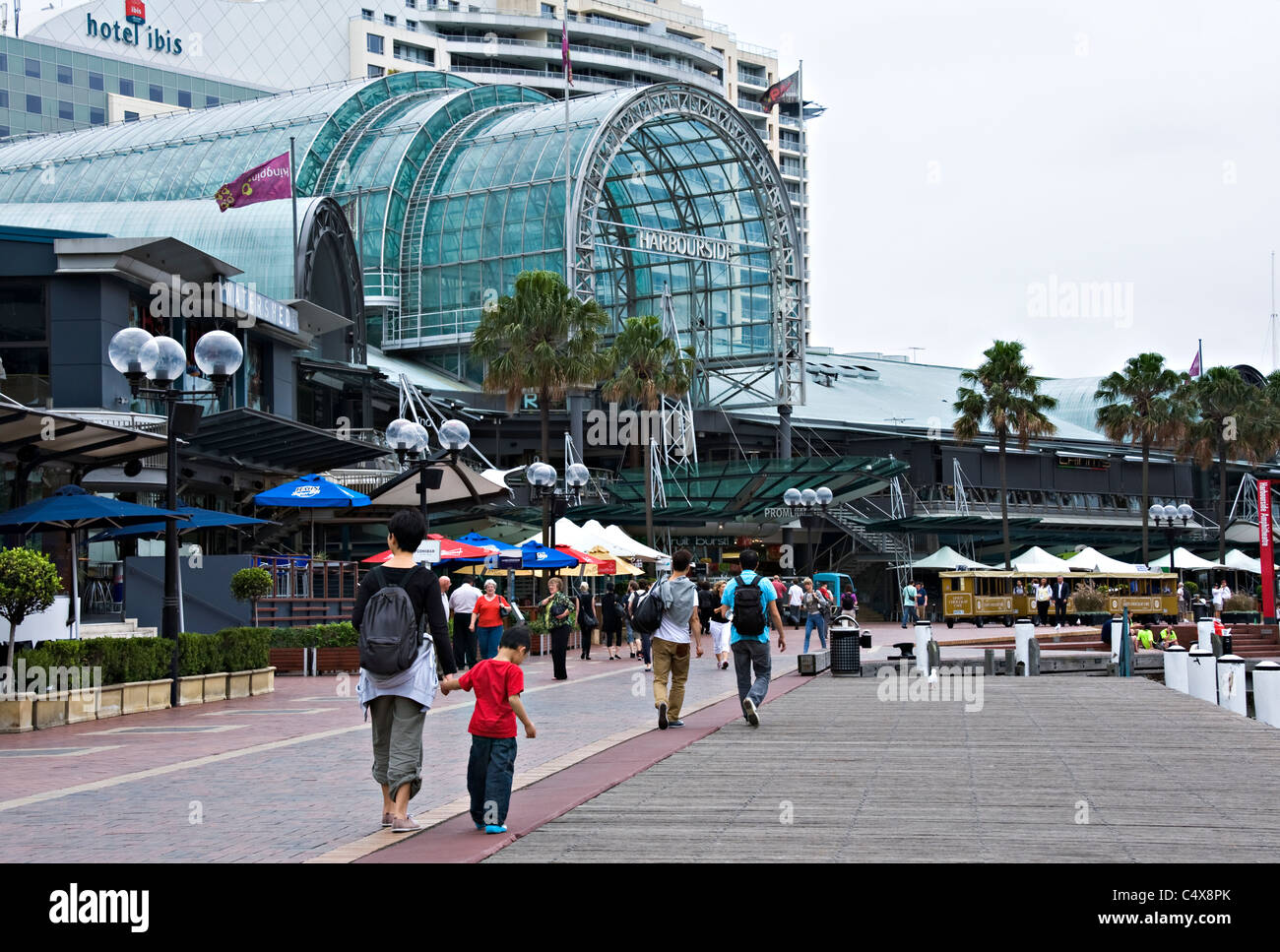 Harbourside Promenade Entrance and Large Paved Forecourt with Tourist Train at Darling Harbour Sydney New South Wales Australia Stock Photo