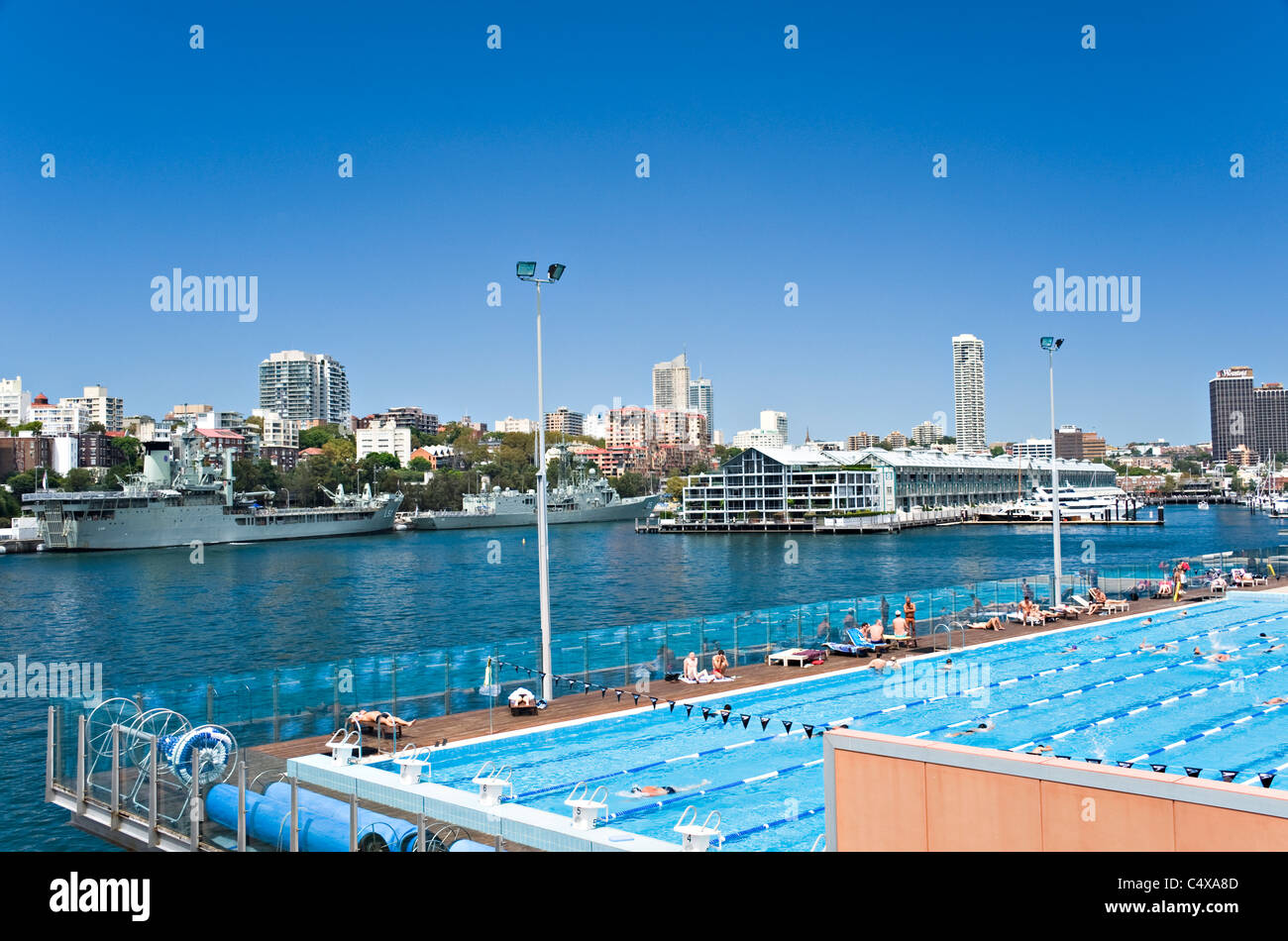 Large Open Air Swimming Pool in Woolloomooloo Bay with The Wharf Shopping Mall and Naval Dockyard Sydney NSW Australia Stock Photo