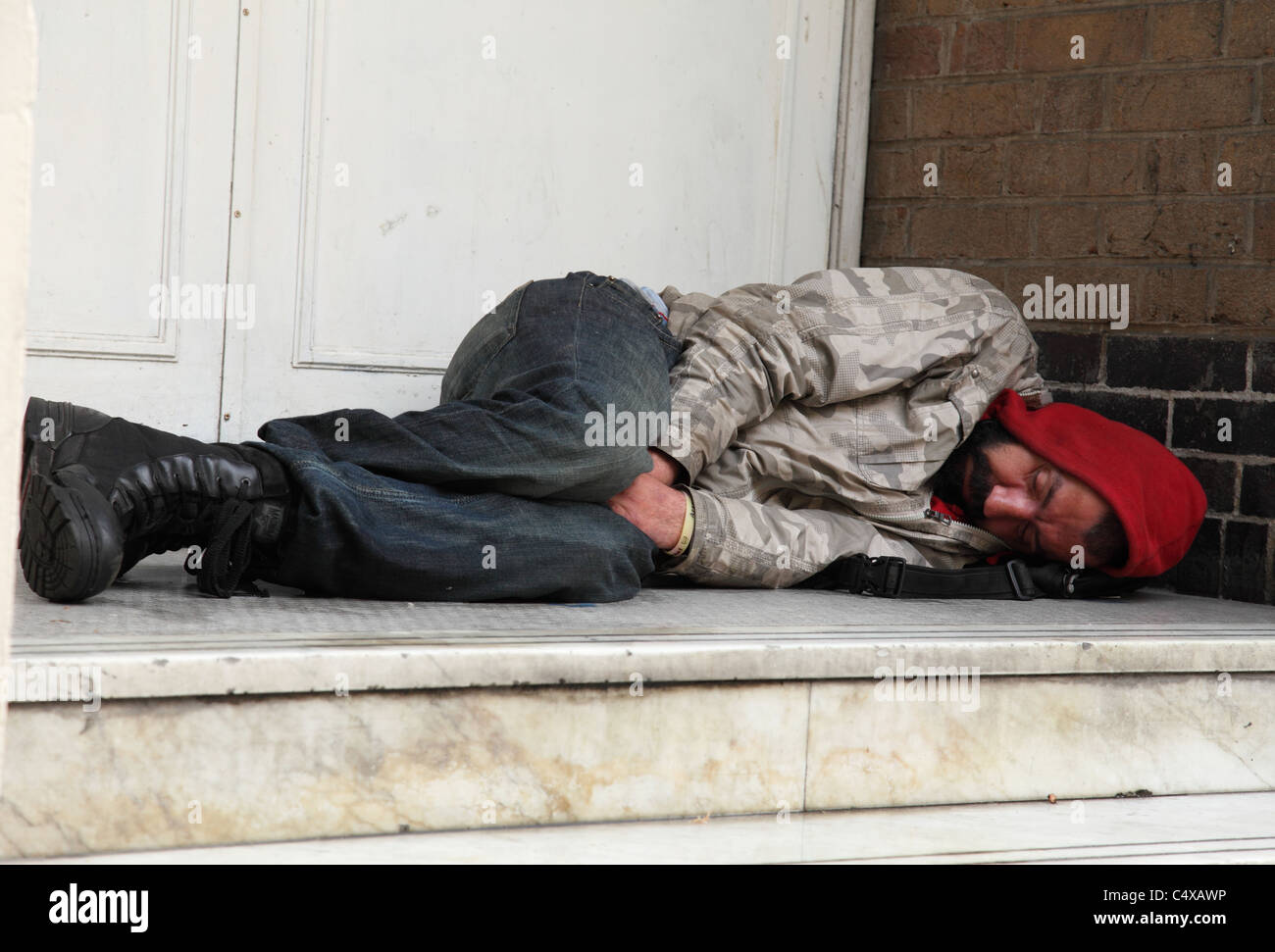 A homeless man  sleeping rough in a doorway in a U.K. city. Stock Photo