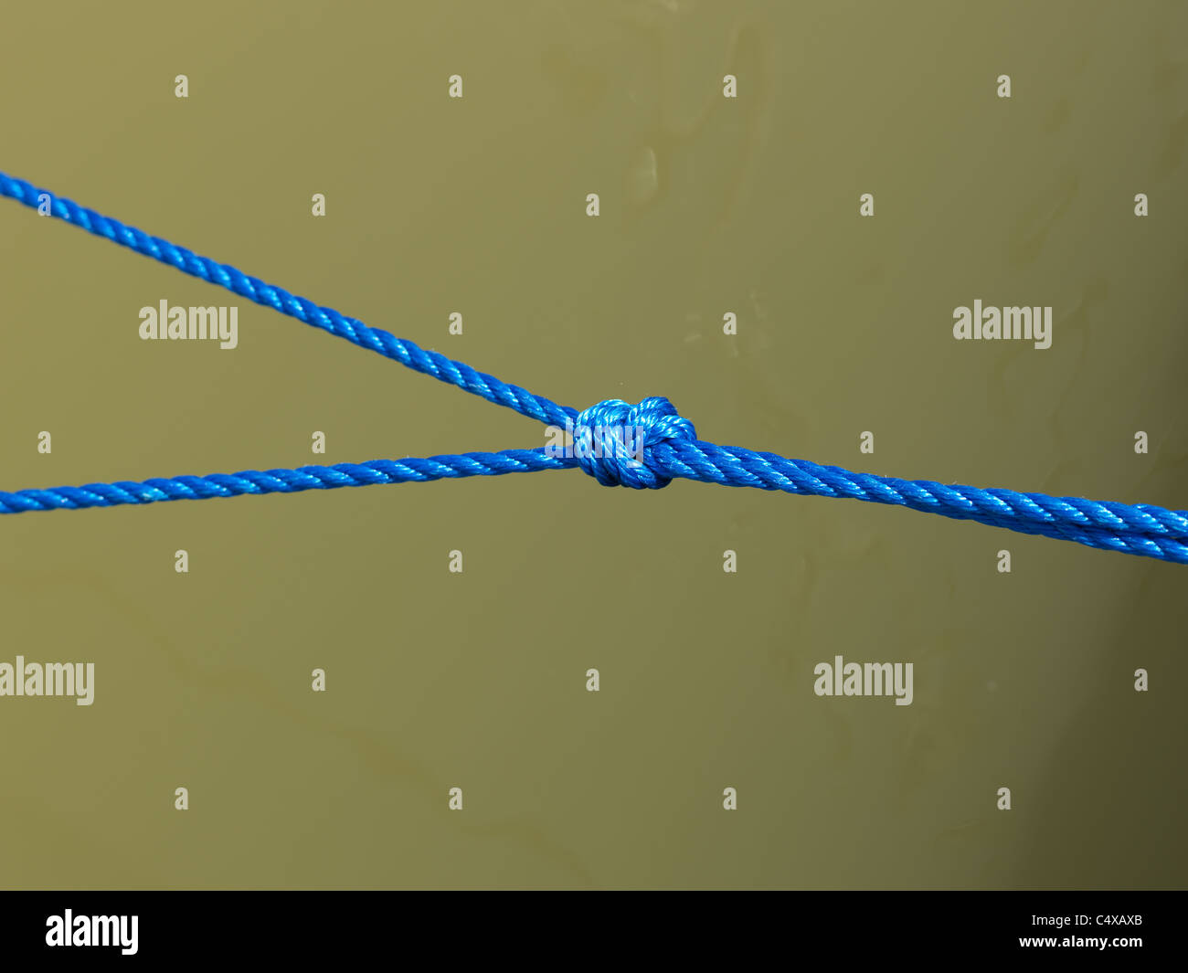 Blue knot over water Stock Photo - Alamy