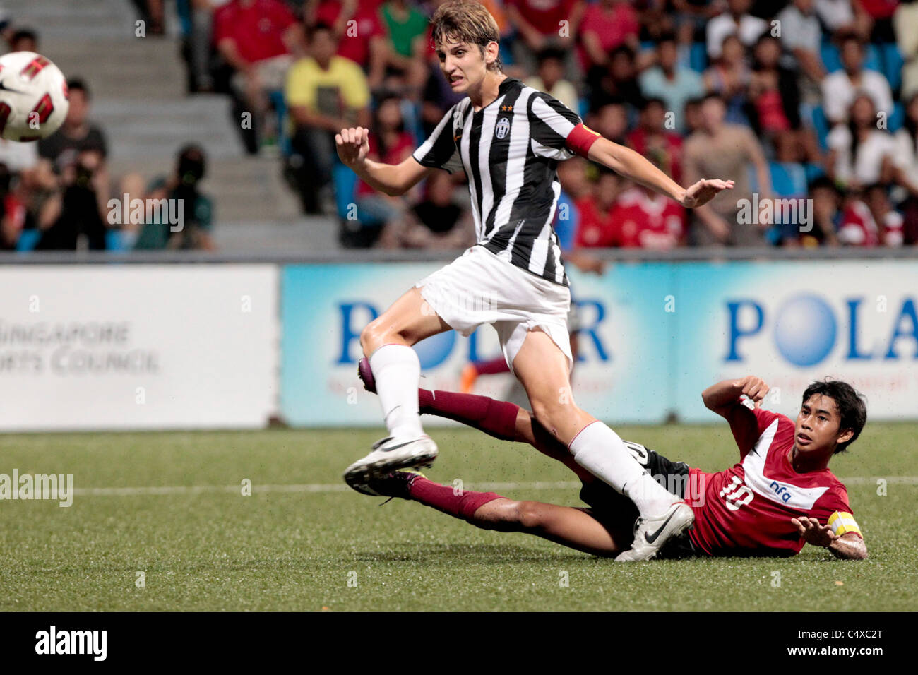 Adam Swandi of Singapore U15(red) takes a shot at goal while Guiducci
