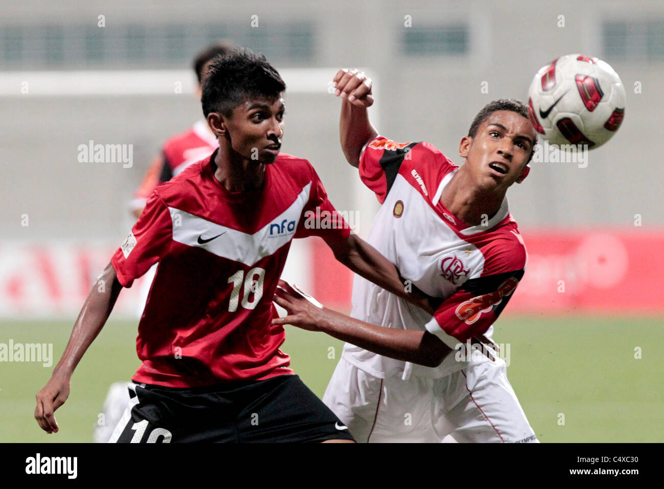 Jorge Marco of CR Flamengo U15(right) and Hanafi Akbar battle for the ball during the 23rd Canon Lion City Cup Stock Photo