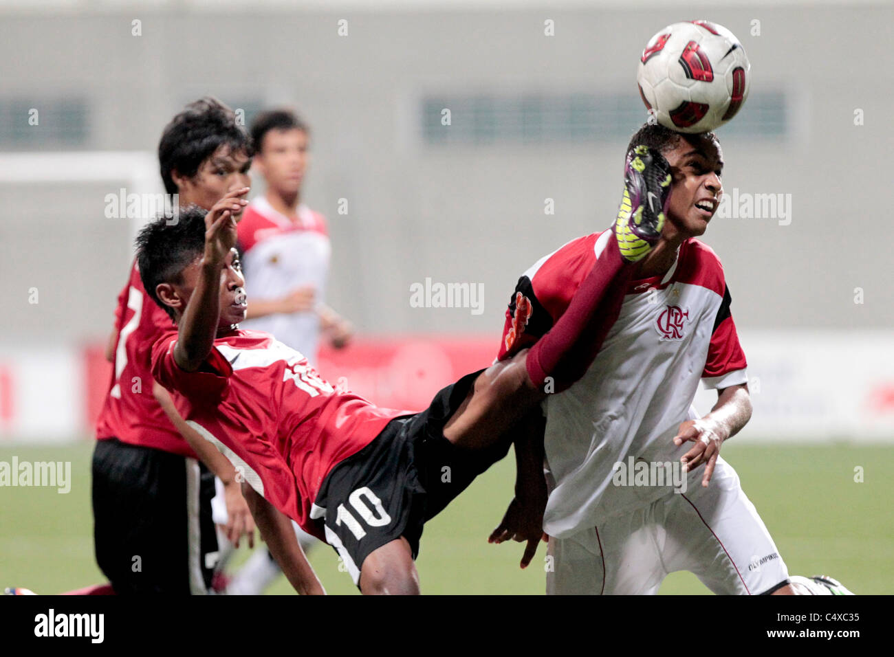 Jorge Marco of CR Flamengo U15(right) and Hanafi Akbar battle for the ball during the 23rd Canon Lion City Cup Stock Photo