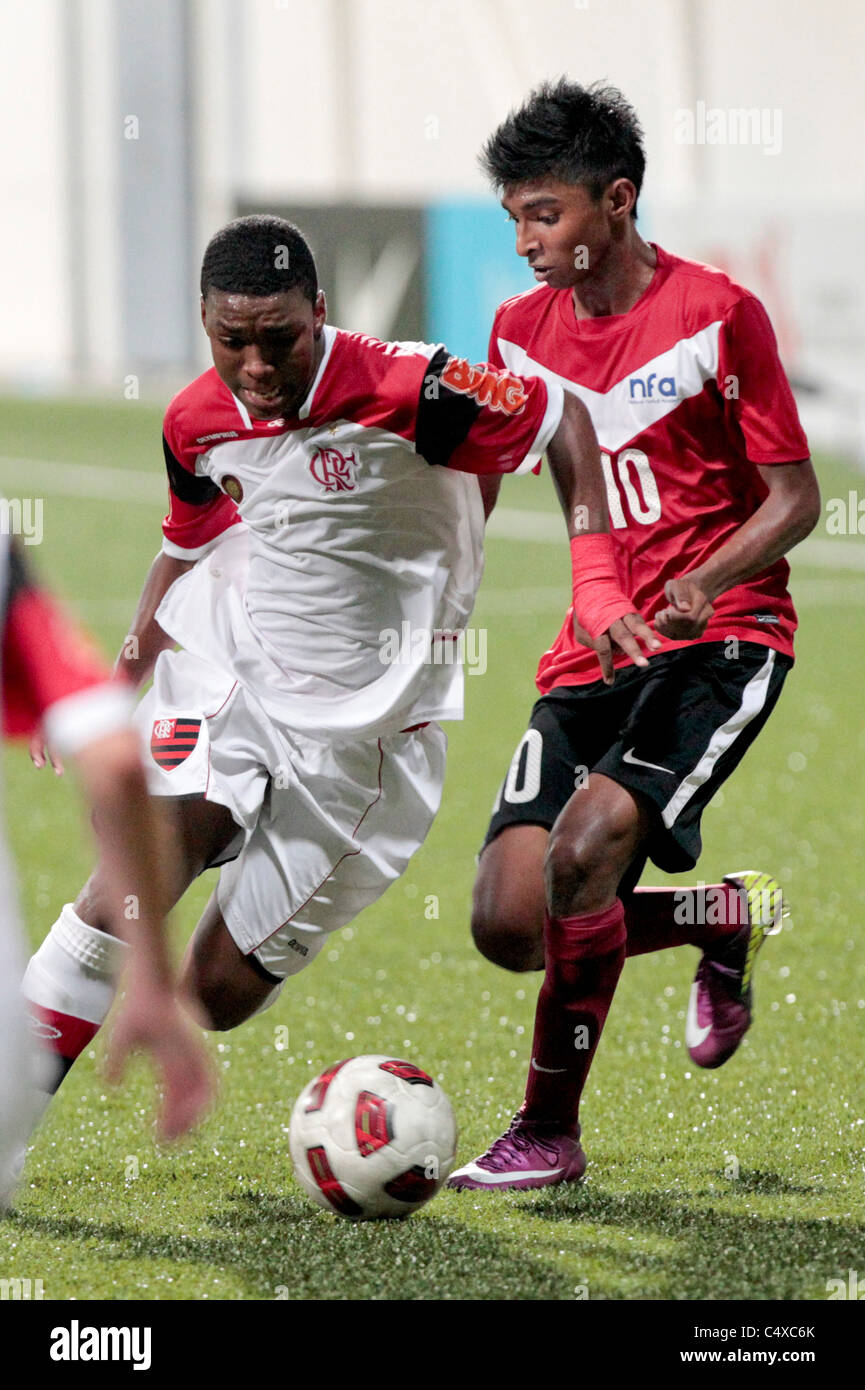 Caio Rangel of CR Flamengo U15(left) turns Hanafi Akbar during the 23rd Canon Lion City Cup Stock Photo