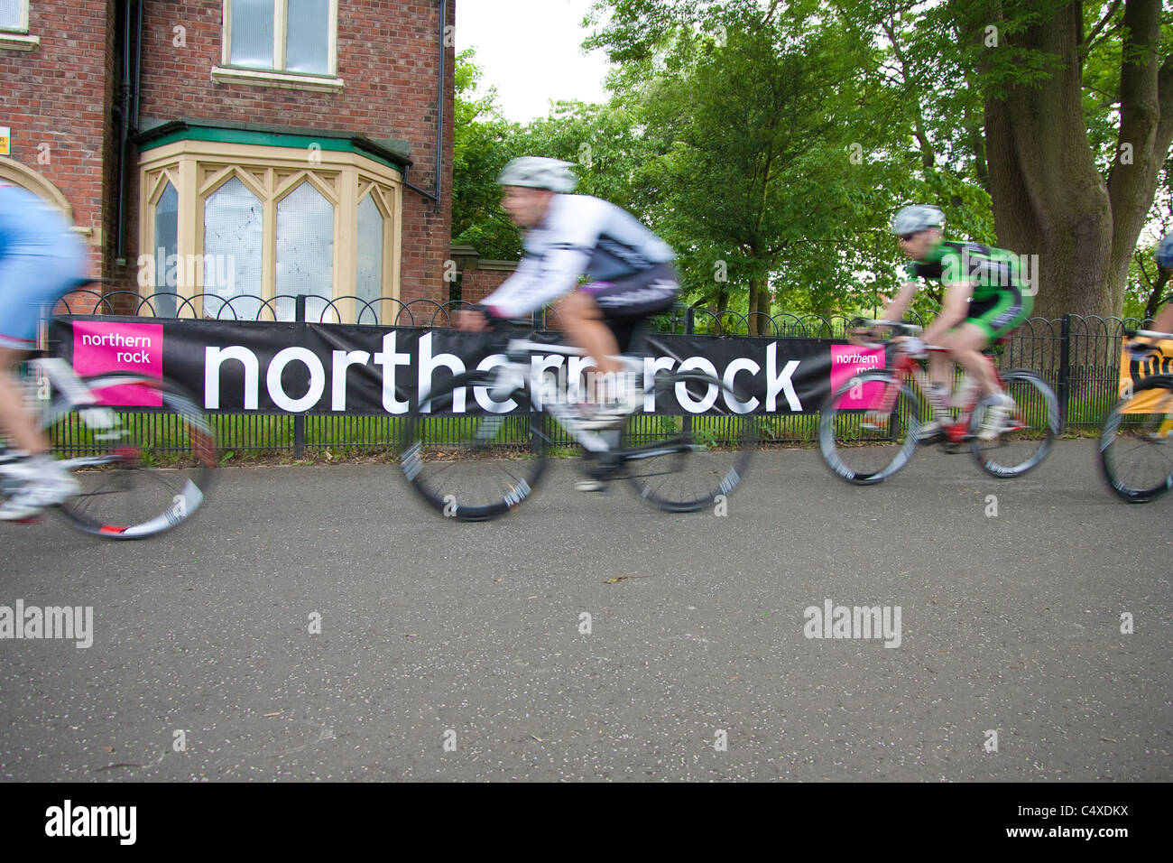 Cyclists passing a Northern Rock banner in the Leazes Criteriums 2011 Stock Photo
