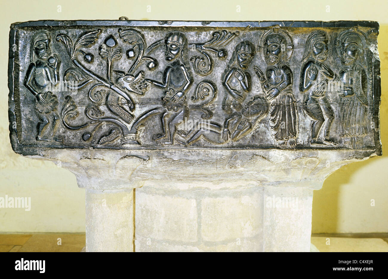 East Meon, Hampshire, black Tournai Marble Norman Font, north face, Temptation of Adam and Eve and The Creation  c.1139 carved Stock Photo