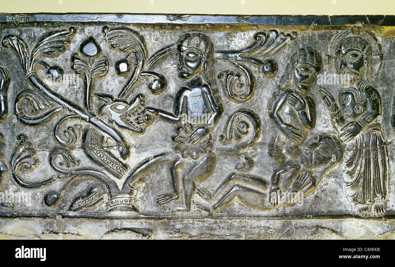 East Meon, Hampshire, black Tournai Marble Norman Font, north side, detail of The Creation of Eve and The Temptation of Adam Stock Photo