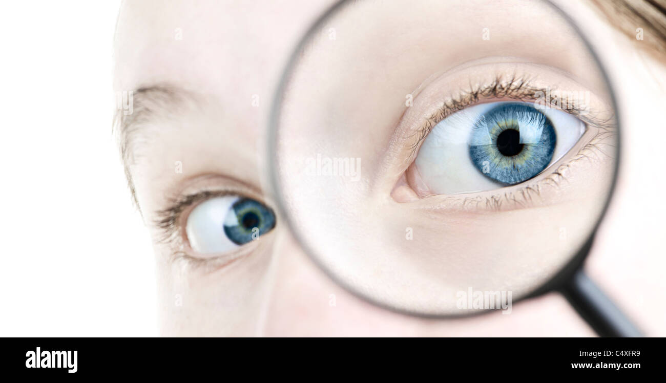 Female blue eye looking through magnifying glass close up Stock Photo ...