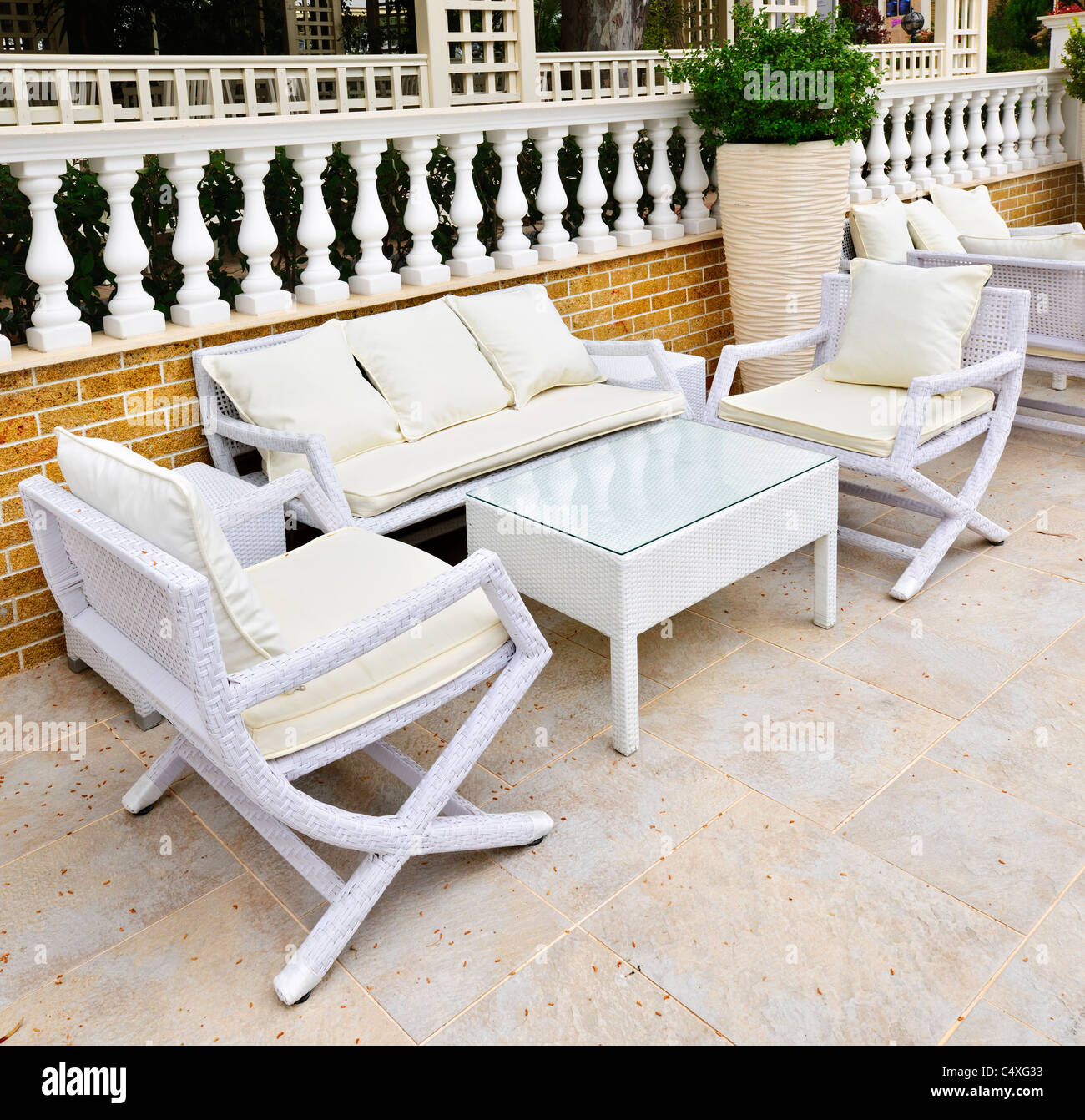 Wicker patio furniture outdoor in area paved with natural stone Stock Photo