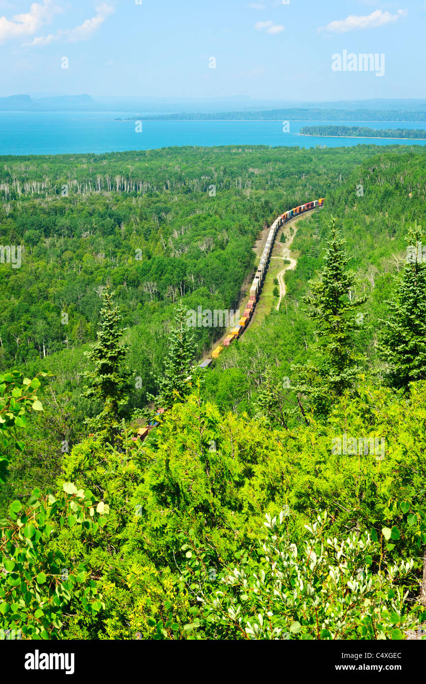 Freight train moving through forest of northern Ontario near Lake Superior in Canada Stock Photo