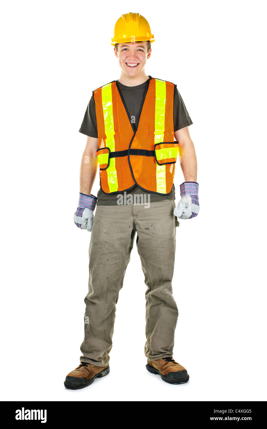 Happy male construction worker standing in safety vest and hard hat Stock Photo