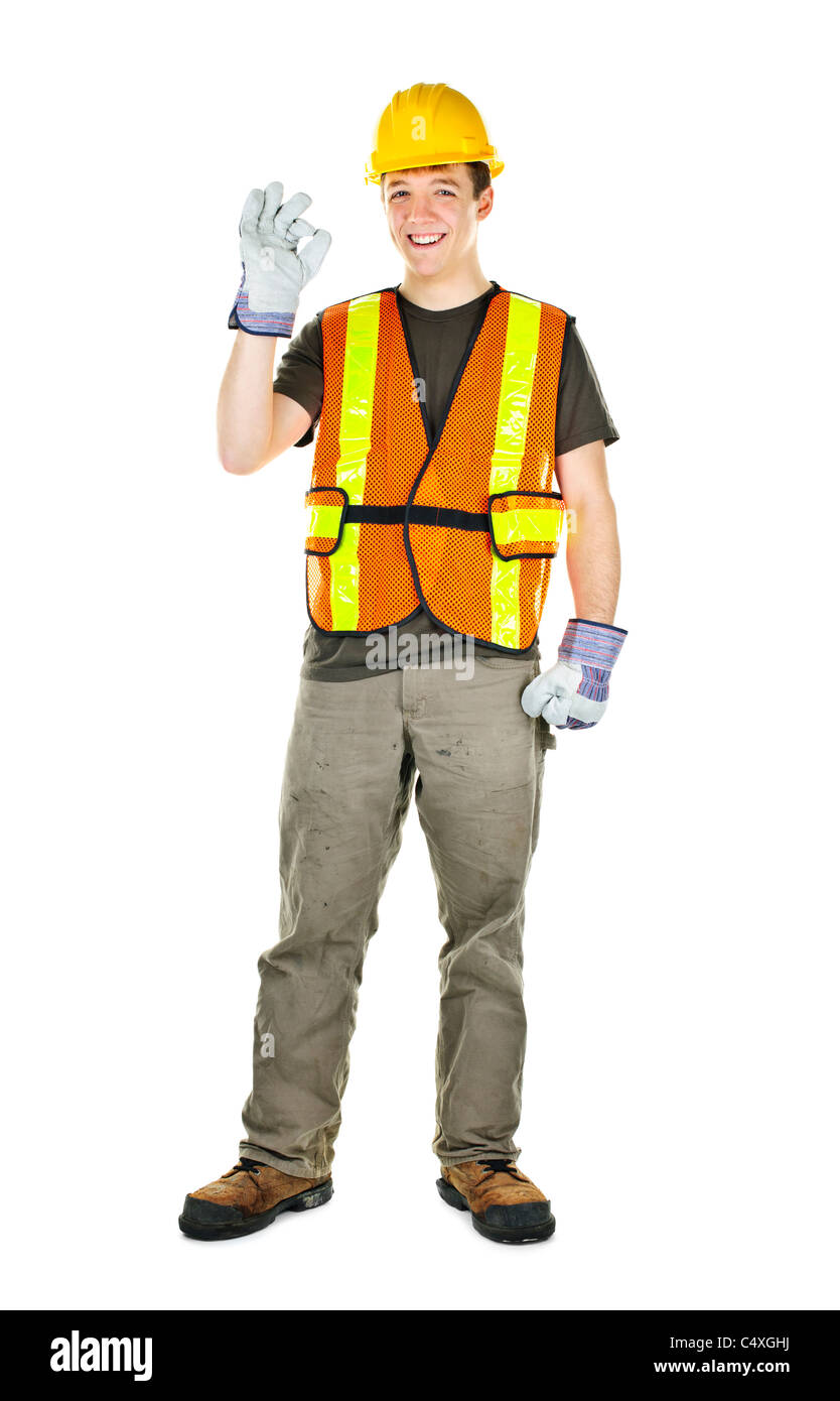 Smiling male construction worker showing okay sign standing isolated on white background Stock Photo