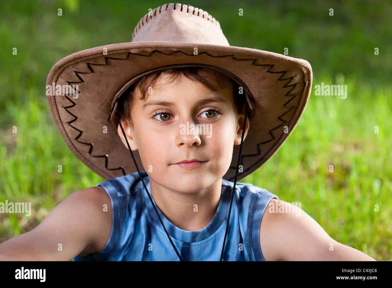 Closeup portrait of a beautiful boy with cowboy hat outdoor Stock Photo