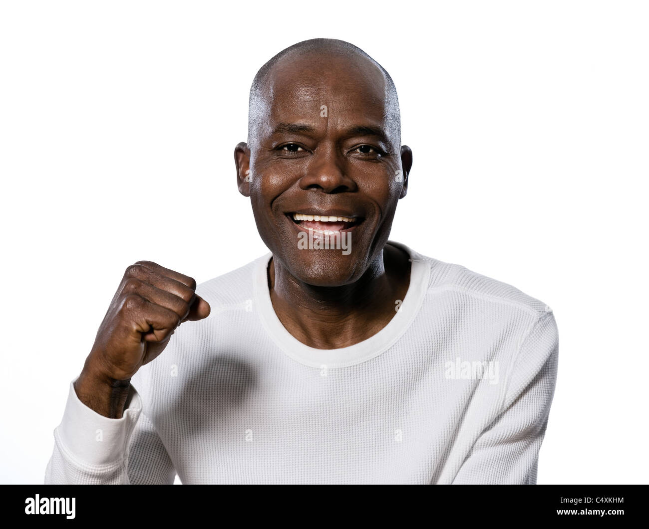 Close-up portrait of an excited afro American man clenching fist in studio on white isolated background Stock Photo