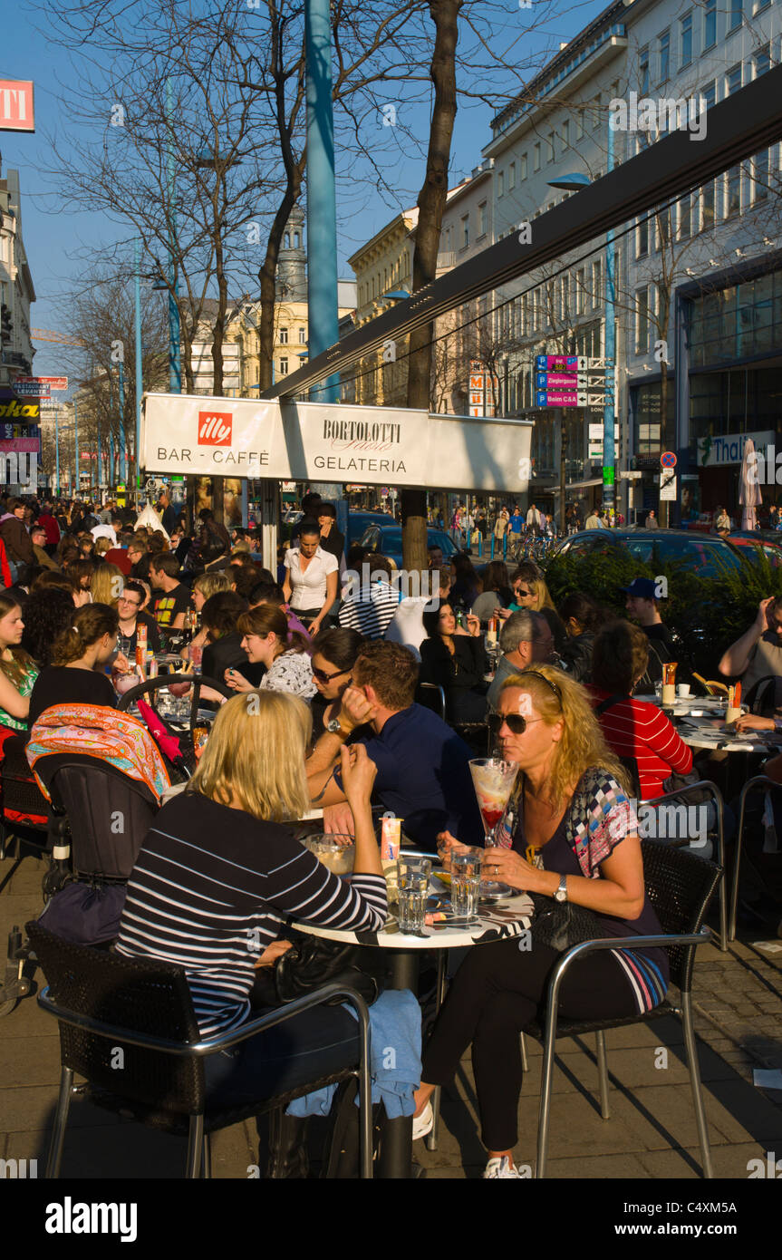 People sitting on cafe terrace Mariahilfer Strasse main shopping street Vienna Austria central Europe Stock Photo