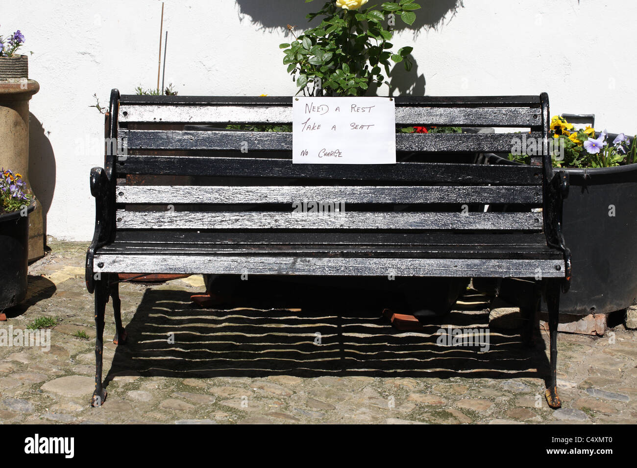 A bench to sit upon free of charge on a steep hill within Richmond, North Yorkshire, England, UK Stock Photo