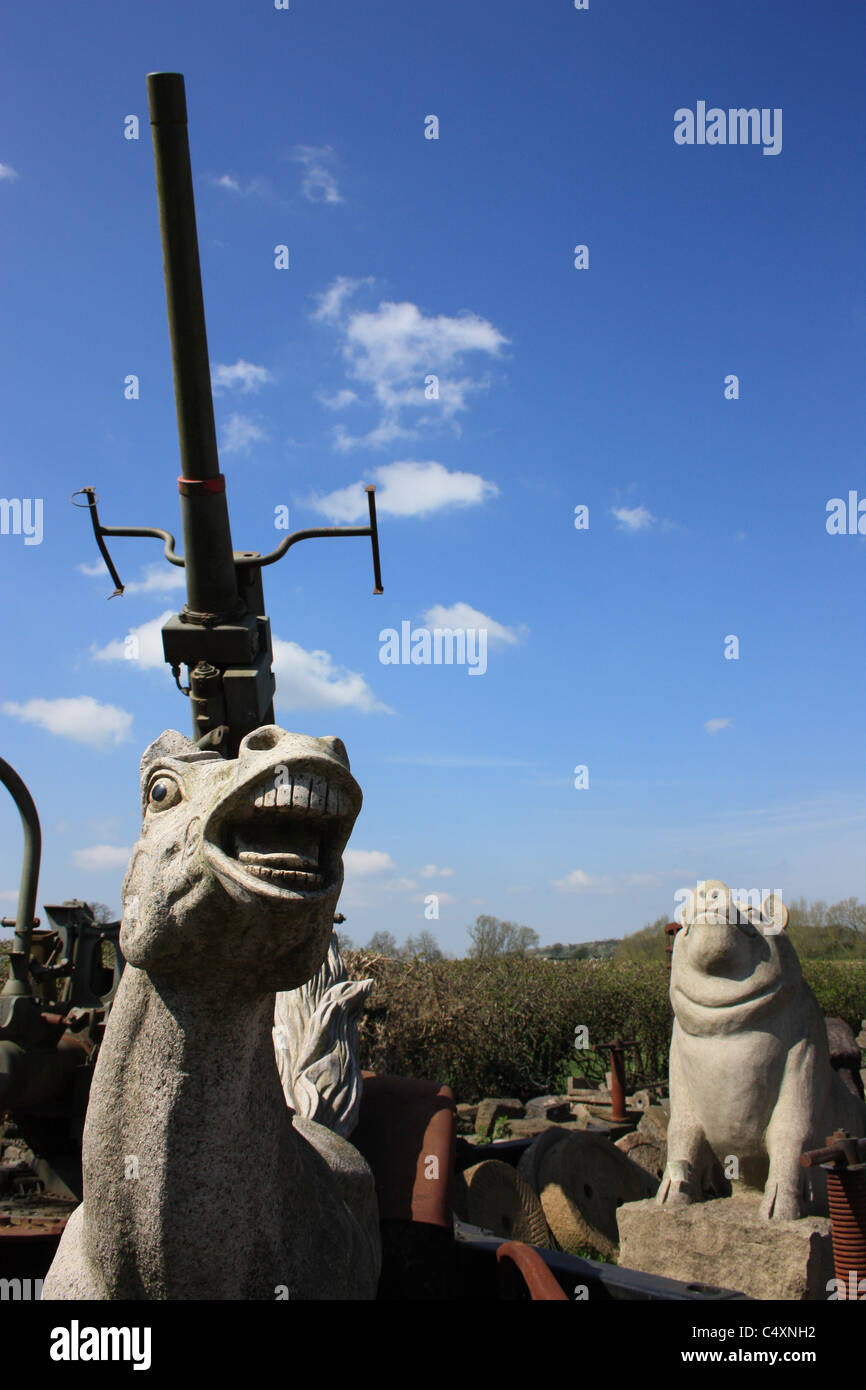 Symbolic depiction of war using statues of horse, pig and gun Stock Photo