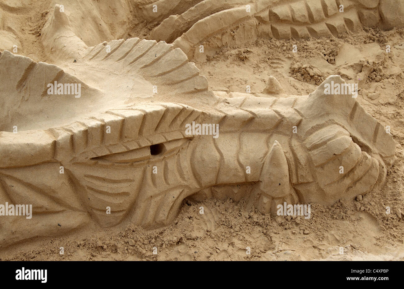 Sand Sculpture of a Dragon on a beach Stock Photo - Alamy