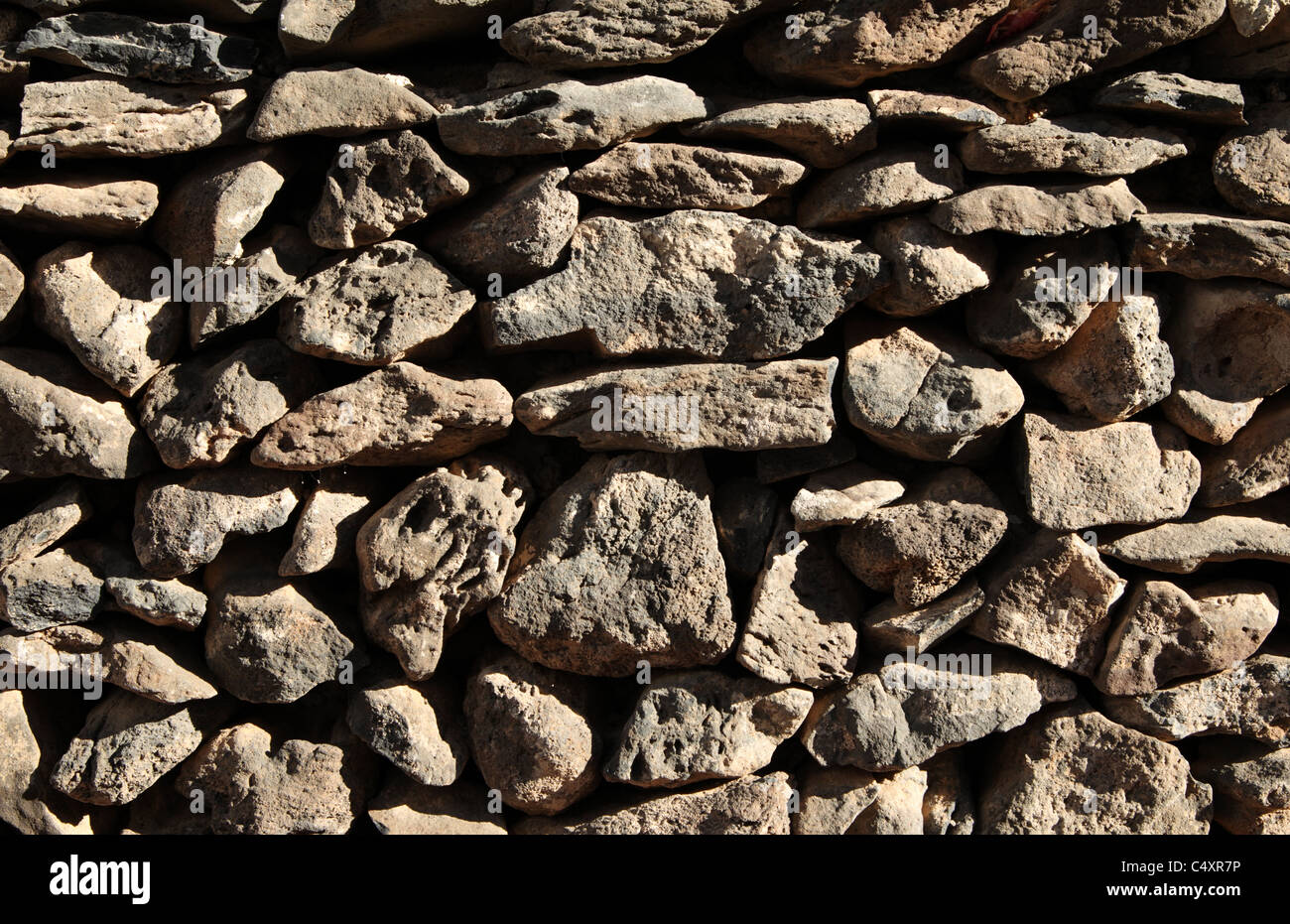 Dry stone wall made from volcanic rock Stock Photo