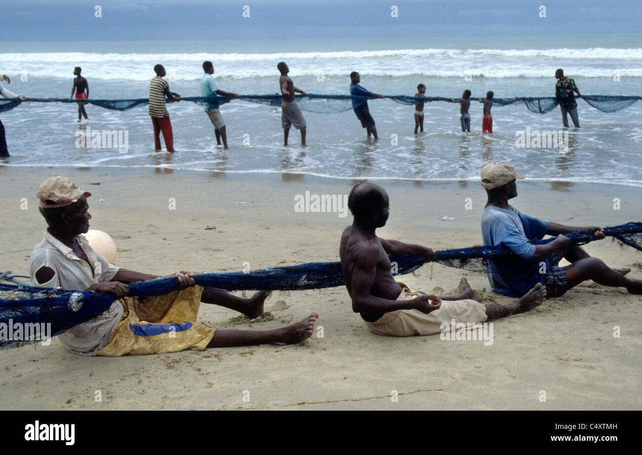 Bringing in large fishing nets from the sea at Kokrobite, a small fishing village near Accra, Ghana Stock Photo