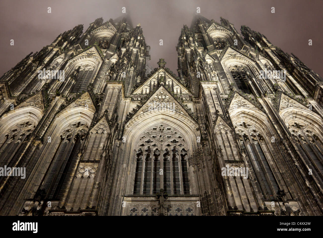 Nightime view of the lit facade of the Cologne Cathedral. Stock Photo