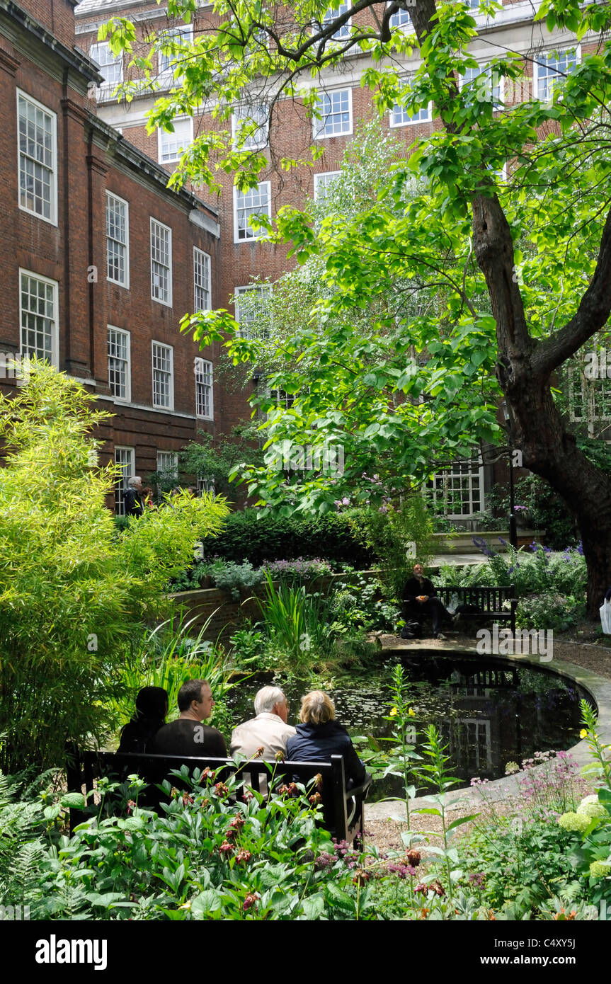 British Medical Association BMA Garden with pond and people sitting, Open Squares and Gardens weekend London England UK Stock Photo