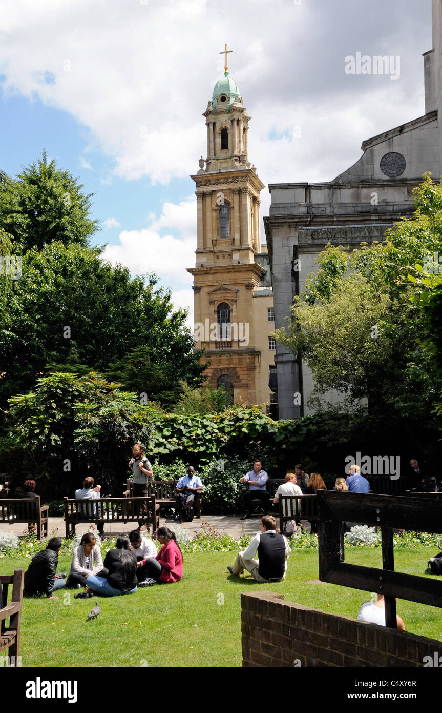 Office workers in the garden of St. Andrew or Andrew's with City Temple United Reformed Church Holborn Viaduct in the background Stock Photo