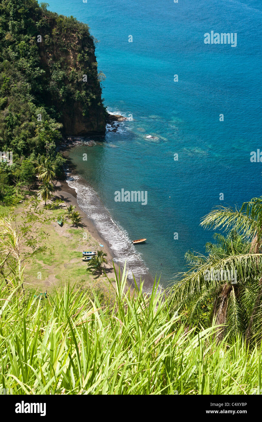 Fishing boat on black sand beach L'Anse Mahaut Bay, St. Vincent and The Grenadines Stock Photo